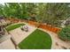 Aerial view of a lush backyard, with a stone patio, seating and bordered by mature trees at 9928 Sylvestor Rd, Highlands Ranch, CO 80129