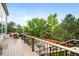 Elevated deck overlooking the serene backyard with mature trees and lounge areas at 9928 Sylvestor Rd, Highlands Ranch, CO 80129