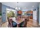 The dining area features a chandelier, wood cabinets, and seamless access to the kitchen at 9928 Sylvestor Rd, Highlands Ranch, CO 80129