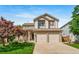 Beautiful two-story house featuring a stone-accented facade, covered porch, and a spacious two-car garage at 9928 Sylvestor Rd, Highlands Ranch, CO 80129