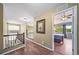 Upstairs hallway leading to a bedroom showcasing wood flooring and a decorative hanging picture at 9928 Sylvestor Rd, Highlands Ranch, CO 80129