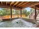 Covered hot tub with wood beam construction and stairs to lush backyard at 9928 Sylvestor Rd, Highlands Ranch, CO 80129