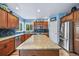 Well-lit kitchen featuring custom cabinets, granite countertops, stainless steel appliances, and a functional center island at 9928 Sylvestor Rd, Highlands Ranch, CO 80129