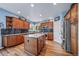 Stylish kitchen with stainless steel appliances, granite countertops, custom cabinets, and a central island at 9928 Sylvestor Rd, Highlands Ranch, CO 80129