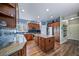 Spacious kitchen featuring custom cabinets, granite countertops, stainless steel appliances, and a central island at 9928 Sylvestor Rd, Highlands Ranch, CO 80129