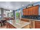 This updated kitchen features stainless steel appliances, granite countertops and backsplash, and seamless flow to dining area at 9928 Sylvestor Rd, Highlands Ranch, CO 80129
