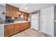 Kitchenette with wooden cabinets, tiled backsplash, and a white refrigerator at 9928 Sylvestor Rd, Highlands Ranch, CO 80129