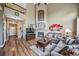 Spacious living room with a fireplace, tall ceilings, and an open view of the staircase at 9928 Sylvestor Rd, Highlands Ranch, CO 80129