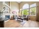 Inviting living room with high ceilings, large arched windows, a stone fireplace, and comfortable seating at 9928 Sylvestor Rd, Highlands Ranch, CO 80129