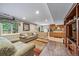 Finished basement living room with wood floors, furniture, and a kitchenette at 9928 Sylvestor Rd, Highlands Ranch, CO 80129