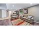 Finished basement with living room, furniture, wood floors, and a window at 9928 Sylvestor Rd, Highlands Ranch, CO 80129