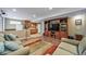 Finished basement living room with wood floors, furniture, and kitchenette at 9928 Sylvestor Rd, Highlands Ranch, CO 80129