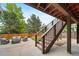 Outdoor patio with seating, stairs, and a view of the backyard at 9928 Sylvestor Rd, Highlands Ranch, CO 80129