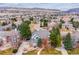 Aerial view of neighborhood showing tree-lined streets and mountain views at 8 Mountain High Ct, Littleton, CO 80127