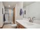 Clean bathroom featuring a single sink vanity, toilet, and a shower with sliding glass doors at 8 Mountain High Ct, Littleton, CO 80127