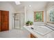 Modern bathroom features a jetted tub and a glass shower at 8 Mountain High Ct, Littleton, CO 80127