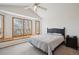 Bright bedroom with a large window seat and a serene view, complemented by a comfortable bed at 8 Mountain High Ct, Littleton, CO 80127