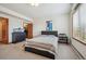 Well-lit bedroom featuring a bed, closet, black dresser, and a window with a radiator underneath at 8 Mountain High Ct, Littleton, CO 80127