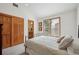 Cozy bedroom with closet, window, and en suite bathroom with neutral colors and calm decor at 8 Mountain High Ct, Littleton, CO 80127