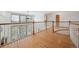 Hallway with hardwood floors, natural light, and white railings at 8 Mountain High Ct, Littleton, CO 80127