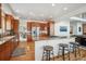 Modern kitchen with granite countertops, stainless steel appliances, wood cabinets, and bar stool seating at 8 Mountain High Ct, Littleton, CO 80127