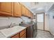 Spacious laundry room with utility sink and modern washer and dryer at 8 Mountain High Ct, Littleton, CO 80127