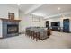 Cozy living room features a stone fireplace, neutral carpet, and relaxed seating at 8 Mountain High Ct, Littleton, CO 80127