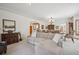 Open-concept living room and dining room, featuring neutral carpet and paint at 8 Mountain High Ct, Littleton, CO 80127