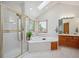 Bright main bathroom with shower, tub, and wooden vanity at 8 Mountain High Ct, Littleton, CO 80127