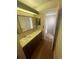 Bathroom featuring double sinks, wood-look flooring, neutral color, and medicine cabinet at 11644 Community Center Dr # 126, Northglenn, CO 80233