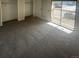 Bedroom with sliding glass doors leading to balcony, closet, and gray carpet at 11644 Community Center Dr # 126, Northglenn, CO 80233