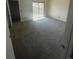 Spacious bedroom with neutral carpet and sliding door to private patio at 11644 Community Center Dr # 126, Northglenn, CO 80233