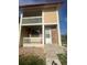 Exterior view showing a private balcony, red brick detail, and covered entry at 11644 Community Center Dr # 126, Northglenn, CO 80233