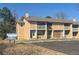 Inviting multi-Gathering home featuring a balcony, yellow siding, and dedicated parking spots for visitors at 11644 Community Center Dr # 126, Northglenn, CO 80233