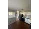 Cozy kitchen featuring wood-look floors, white cabinets, and essential appliances at 11644 Community Center Dr # 126, Northglenn, CO 80233