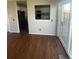 Spacious living room with hardwood floors and direct view into the kitchen area at 11644 Community Center Dr # 126, Northglenn, CO 80233