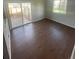 Open living area boasts sleek wood floors, natural light, and a sliding door to the backyard at 11644 Community Center Dr # 126, Northglenn, CO 80233