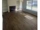 Spacious living room featuring new wood floors, a fireplace, and built-in shelving at 11644 Community Center Dr # 126, Northglenn, CO 80233