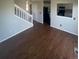 Open-concept living area with hardwood floors, and view into the adjacent kitchen at 11644 Community Center Dr # 126, Northglenn, CO 80233