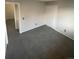 Spacious carpeted living room with neutral color scheme and access to other rooms at 11644 Community Center Dr # 126, Northglenn, CO 80233