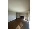 Living room featuring new wood floors, a fireplace, and built-in shelving at 11644 Community Center Dr # 126, Northglenn, CO 80233