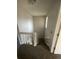 Carpeted stairs and landing area are brightened by a small window and light-colored walls at 11644 Community Center Dr # 126, Northglenn, CO 80233