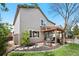 View of the house's backyard with a covered patio and stone landscaping around the lawn at 10512 Hyacinth St, Highlands Ranch, CO 80129