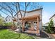 Well-maintained backyard featuring a deck, stone landscaping, a spacious lawn, and mature trees at 10512 Hyacinth St, Highlands Ranch, CO 80129