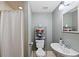 Cozy bathroom featuring a toilet, sink, mirror, and shower with tiled floors at 10512 Hyacinth St, Highlands Ranch, CO 80129