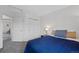 Bedroom features a large window, neutral carpet, a closet with sliding doors, and a queen bed at 10512 Hyacinth St, Highlands Ranch, CO 80129