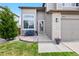Inviting front entrance with charming brick accents and a cozy seating area, enhancing curb appeal at 10512 Hyacinth St, Highlands Ranch, CO 80129