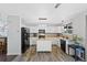 Bright kitchen with modern appliances, an island, wooden floors, and plenty of cabinet space, perfect for cooking at 10512 Hyacinth St, Highlands Ranch, CO 80129