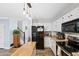 This kitchen boasts stainless appliances, wooden floors and a center island with an open staircase nearby at 10512 Hyacinth St, Highlands Ranch, CO 80129