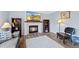 Cozy living room features a fireplace, hardwood floors, and plenty of natural light at 10512 Hyacinth St, Highlands Ranch, CO 80129
